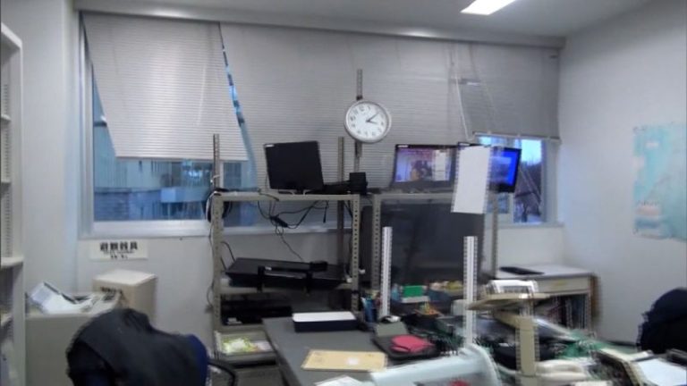 Earthquake survivors in Japan sleep in coats and hats at shelters without heat or running water